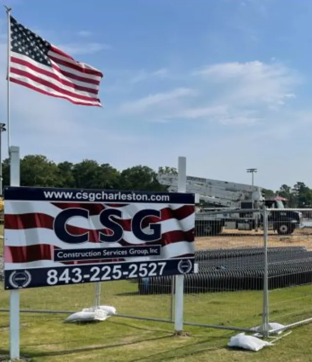 Construction Services Group sign with American flag at a commercial job site